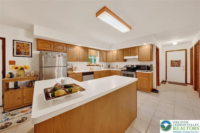 146 Bernadette Dr, Pike, PA 18328 - kitchen featuring appliances with stainless steel finishes, under cabinet range hood, light countertops, light tile patterned floors, and a sink