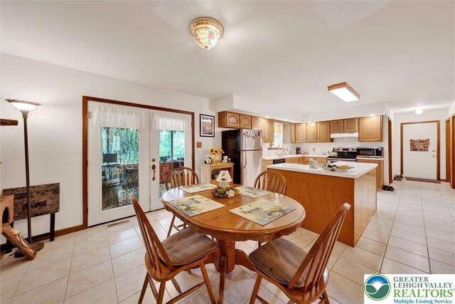 146 Bernadette Dr, Pike, PA 18328 - dining space featuring light tile patterned floors, french doors, and baseboards