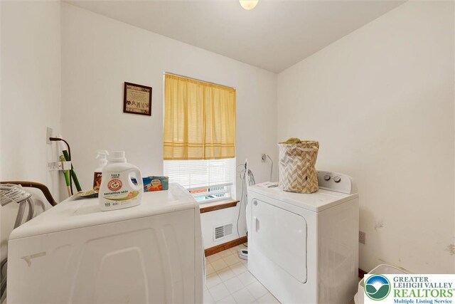 146 Bernadette Dr, Pike, PA 18328 - laundry area featuring washing machine and clothes dryer, light tile patterned floors, and baseboards