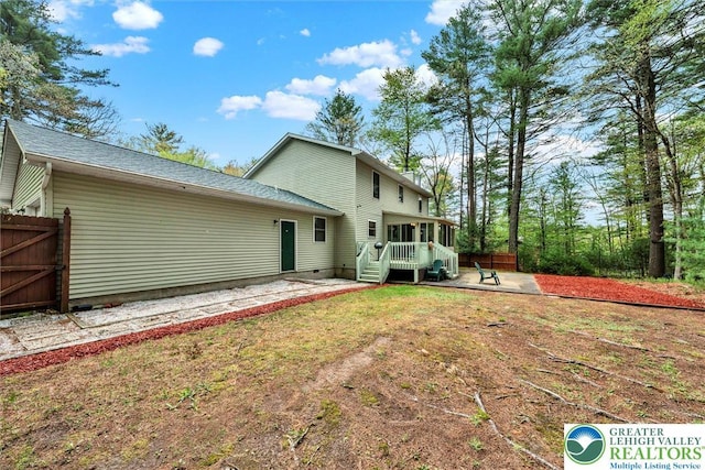 146 Bernadette Dr, Pike, PA 18328 - rear view of house featuring a patio area, a sunroom, and roof with shingles