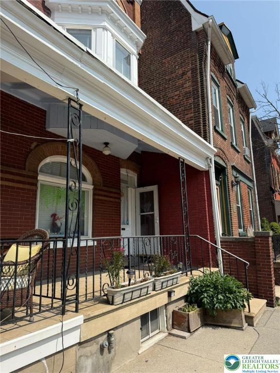 511 N 8th St, Allentown City, PA 18102 - view of property exterior with brick siding and a porch
