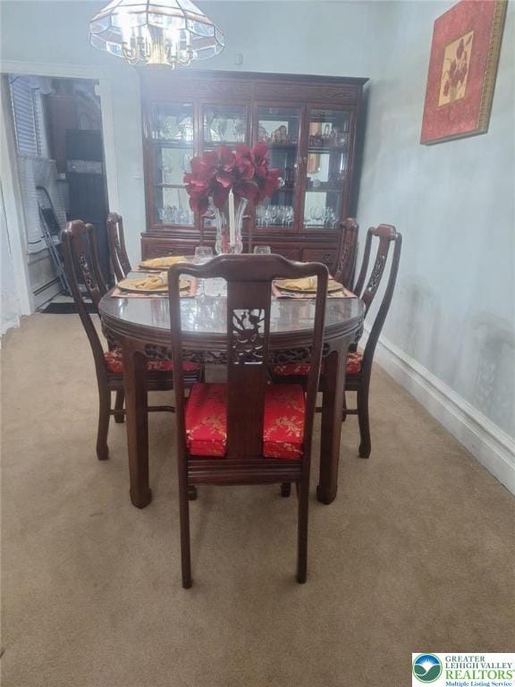 511 N 8th St, Allentown City, PA 18102 - carpeted dining room featuring a chandelier and baseboards