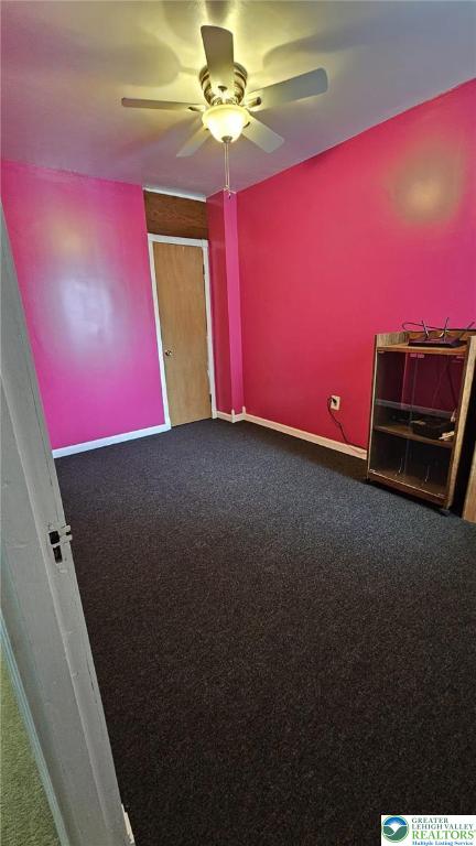 511 N 8th St, Allentown City, PA 18102 - empty room with dark carpet, ceiling fan, and baseboards