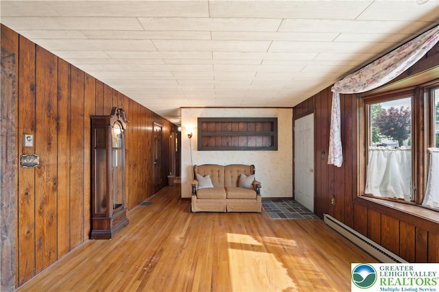155 7th St, Tatamy Borough, PA 18085 - entryway featuring a baseboard heating unit, light wood-style flooring, and wood walls