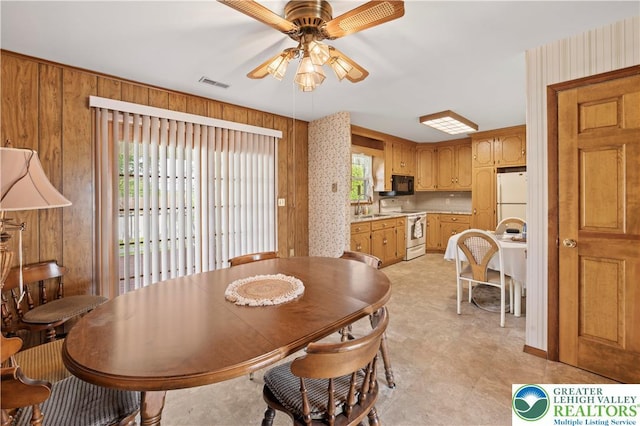 155 7th St, Tatamy Borough, PA 18085 - dining room with a ceiling fan and wooden walls