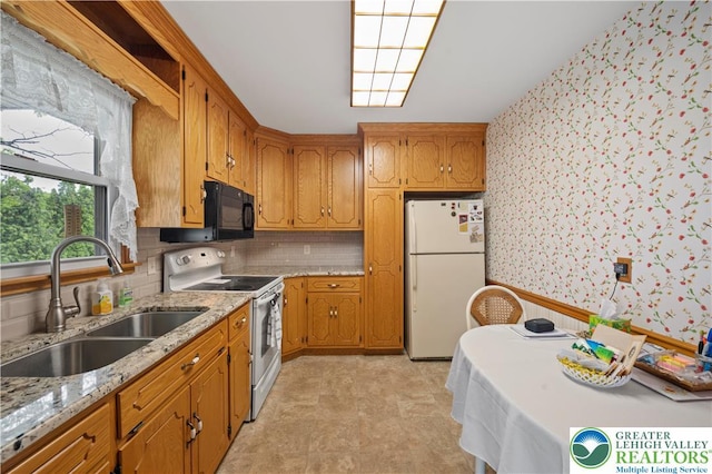 155 7th St, Tatamy Borough, PA 18085 - kitchen with white appliances, a sink, wallpapered walls, brown cabinetry, and backsplash