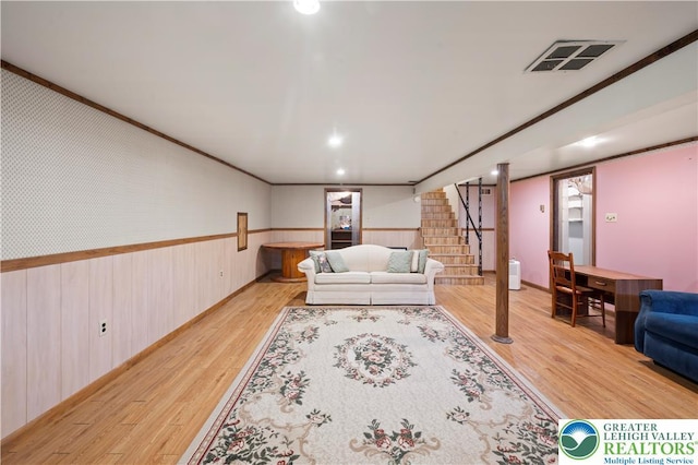 155 7th St, Tatamy Borough, PA 18085 - living room with wood finished floors, stairway, a wainscoted wall, wood walls, and crown molding