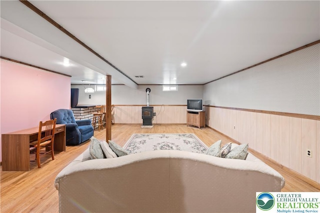 155 7th St, Tatamy Borough, PA 18085 - living room with a wainscoted wall, a wood stove, and light wood-type flooring