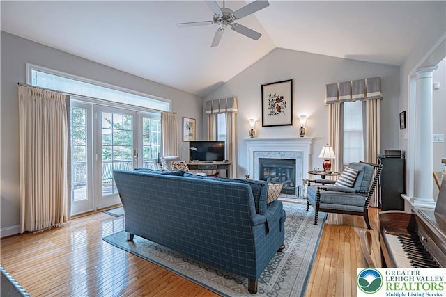 538 Parkside Ct, Allentown City, PA 18104 - living area with a premium fireplace, a ceiling fan, lofted ceiling, light wood-style flooring, and decorative columns