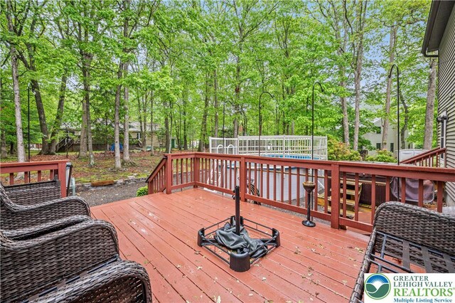 1117 Belaire Dr, Stroud Twp, PA 18301 - deck featuring view of wooded area