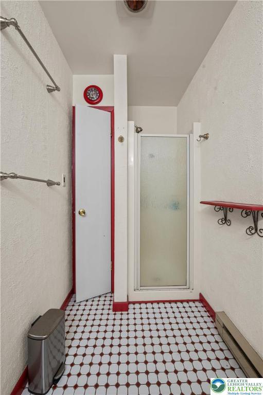 1117 Belaire Dr, Stroud Twp, PA 18301 - bathroom featuring a shower stall and a baseboard radiator