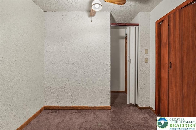 1117 Belaire Dr, Stroud Twp, PA 18301 - hall featuring a textured wall, carpet, a textured ceiling, and baseboards