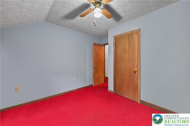 1117 Belaire Dr, Stroud Twp, PA 18301 - unfurnished bedroom with a textured ceiling, baseboards, vaulted ceiling, carpet, and ceiling fan