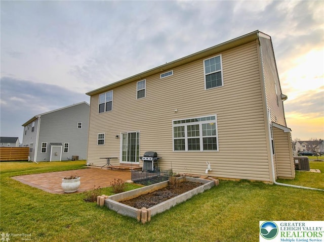 9 Krocks Rd, Upper Macungie Twp, PA 18104 - back of property at dusk with a patio area, a lawn, and cooling unit