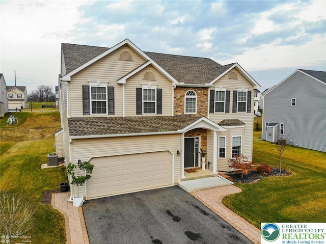 9 Krocks Rd, Upper Macungie Twp, PA 18104 - traditional home featuring an attached garage, roof with shingles, central AC, and a front yard