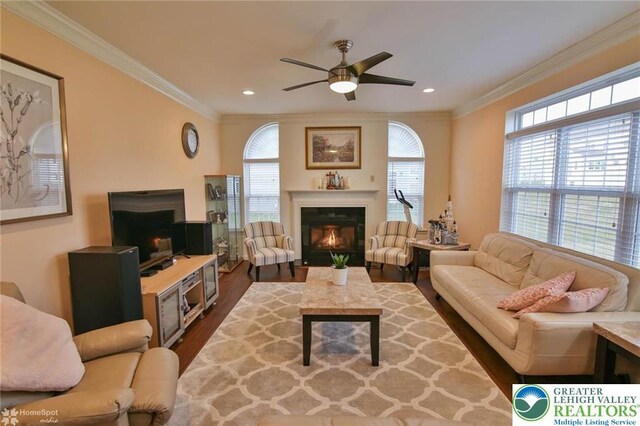 9 Krocks Rd, Upper Macungie Twp, PA 18104 - living room featuring a glass covered fireplace, a ceiling fan, dark wood-style flooring, ornamental molding, and recessed lighting
