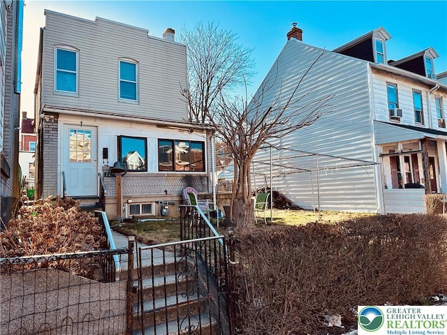 742 N 4th St, Allentown City, PA 18102 - view of front of home featuring a fenced front yard, a chimney, a gate, and cooling unit