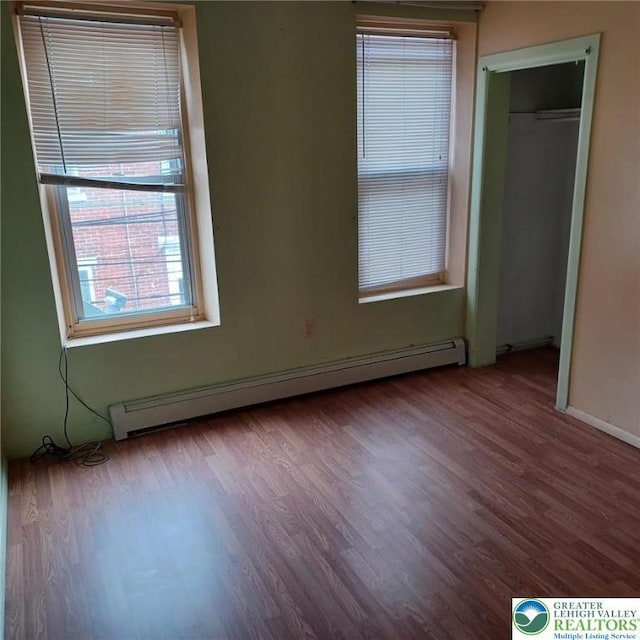 617 Oak St, Allentown City, PA 18102 - unfurnished bedroom with baseboard heating and wood finished floors