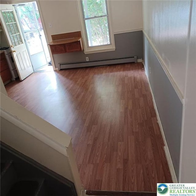 617 Oak St, Allentown City, PA 18102 - spare room featuring baseboard heating, wood finished floors, and healthy amount of natural light