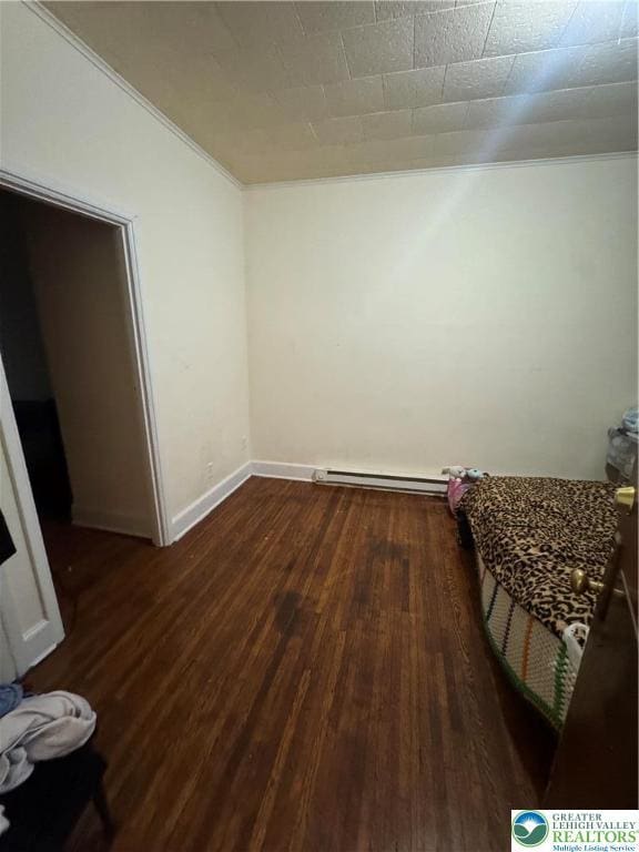 734 W Gordon St, Allentown City, PA 18102 - unfurnished bedroom with dark wood-style flooring, a baseboard radiator, ornamental molding, and baseboards