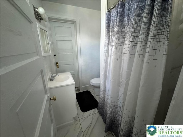 734 W Gordon St, Allentown City, PA 18102 - bathroom featuring marble look tiles, vanity, toilet, and a shower with curtain