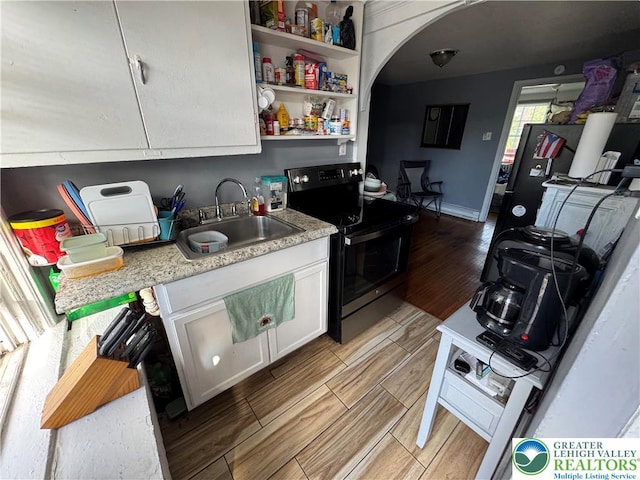 734 W Gordon St, Allentown City, PA 18102 - kitchen featuring electric range, a sink, wood tiled floors, white cabinetry, and light countertops