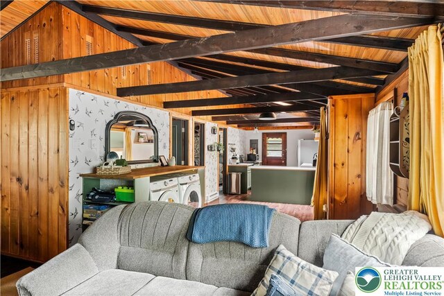 105 Honovi Dr, Tobyhanna Twp, PA 18347 - living area featuring washing machine and clothes dryer, wood finished floors, wooden walls, and wooden ceiling with exposed beams