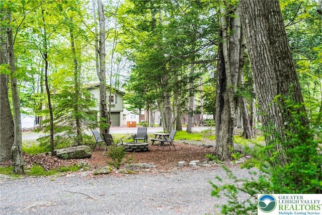 105 Honovi Dr, Tobyhanna Twp, PA 18347 - view of yard with an outdoor fire pit and a garage