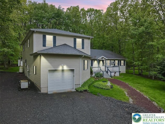 54 Indian Trl, Penn Forest Township, PA 18229 - view of front of house featuring a lawn, a garage, and gravel driveway