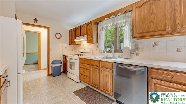 54 Indian Trl, Penn Forest Township, PA 18229 - kitchen with white appliances, under cabinet range hood, a sink, tasteful backsplash, and light countertops