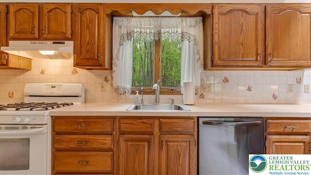 54 Indian Trl, Penn Forest Township, PA 18229 - kitchen featuring stainless steel dishwasher, white gas range, under cabinet range hood, a sink, and light countertops