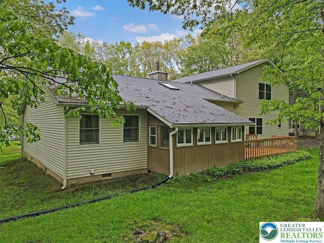 54 Indian Trl, Penn Forest Township, PA 18229 - rear view of property featuring a deck, a lawn, a chimney, and a shingled roof