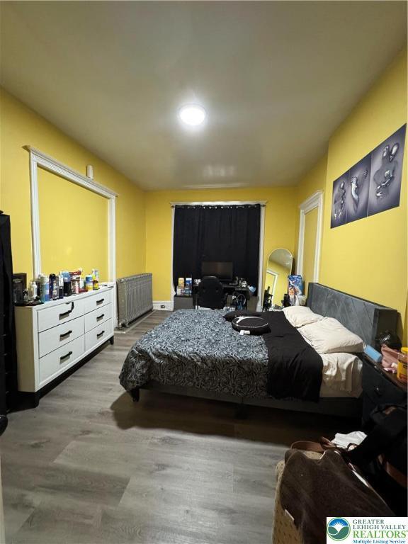 528 N 6th St, Allentown City, PA 18102 - bedroom featuring radiator heating unit and wood finished floors