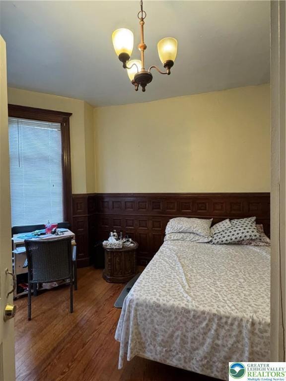 528 N 6th St, Allentown City, PA 18102 - bedroom with wood finished floors, a chandelier, and wainscoting