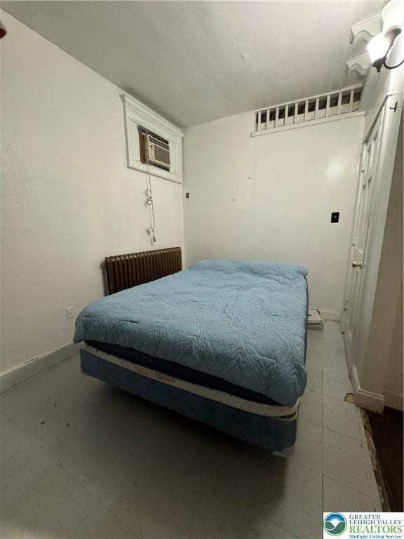 528 N 6th St, Allentown City, PA 18102 - bedroom with radiator heating unit, a wall mounted air conditioner, and baseboards