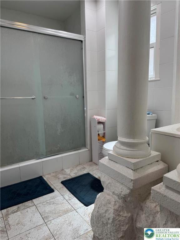 528 N 6th St, Allentown City, PA 18102 - bathroom featuring toilet, a shower stall, vanity, tile walls, and tile patterned flooring