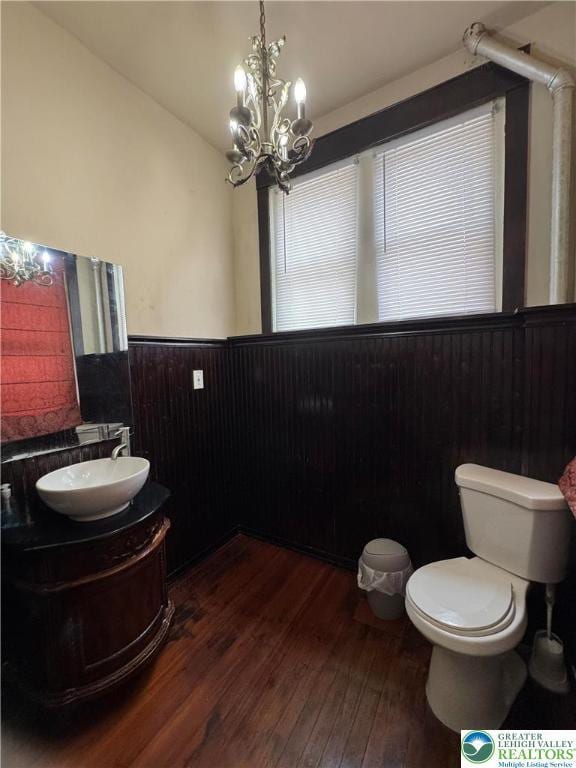 528 N 6th St, Allentown City, PA 18102 - bathroom featuring hardwood / wood-style flooring, wainscoting, toilet, vanity, and a chandelier