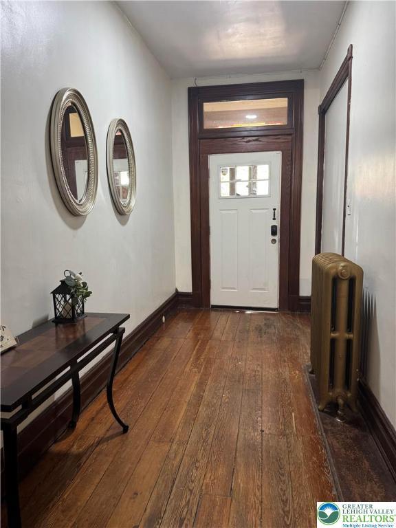 528 N 6th St, Allentown City, PA 18102 - entryway featuring radiator, dark wood-type flooring, and baseboards