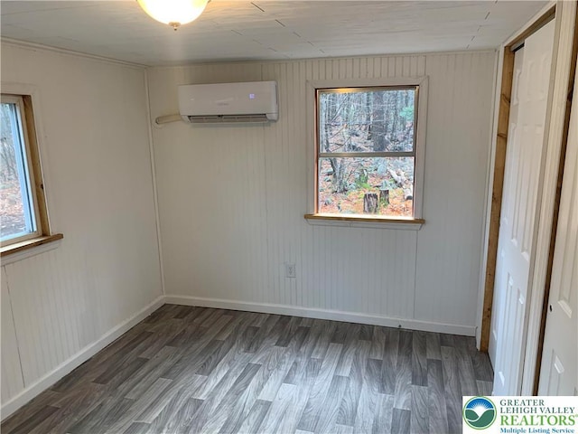 112 Aspen Dr, Penn Forest Township, PA 18210 - spare room featuring a wall unit AC, wood finished floors, and baseboards