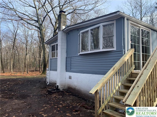 112 Aspen Dr, Penn Forest Township, PA 18210 - view of property exterior featuring a chimney and crawl space