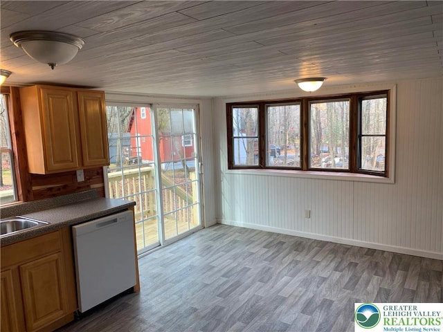 112 Aspen Dr, Penn Forest Township, PA 18210 - kitchen featuring white dishwasher, dark countertops, wood finished floors, baseboards, and a sink
