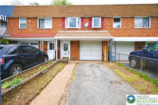 639 Dixon St, Allentown City, PA 18103 - multi unit property featuring driveway, brick siding, an attached garage, and roof with shingles