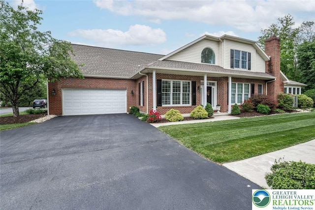 4741 Pinehurst Cir, Upper Saucon Twp, PA 18034 - traditional home with driveway, a garage, brick siding, a front yard, and a chimney