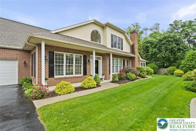 4741 Pinehurst Cir, Upper Saucon Twp, PA 18034 - traditional-style house featuring brick siding, roof with shingles, a chimney, and asphalt driveway