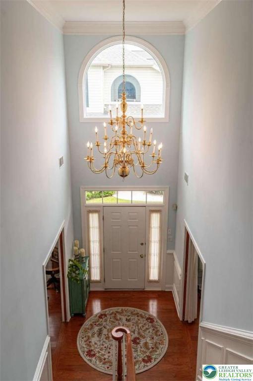 4741 Pinehurst Cir, Upper Saucon Twp, PA 18034 - entryway with a chandelier, wood finished floors, healthy amount of natural light, a towering ceiling, and crown molding