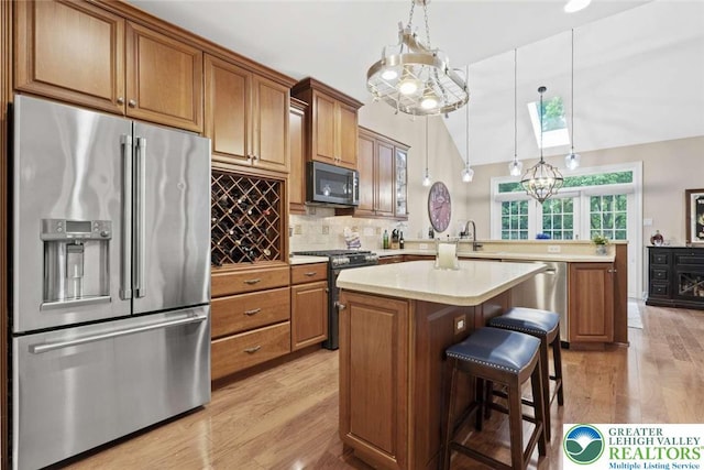4741 Pinehurst Cir, Upper Saucon Twp, PA 18034 - kitchen with stainless steel appliances, light wood-style flooring, light countertops, a peninsula, and a kitchen island