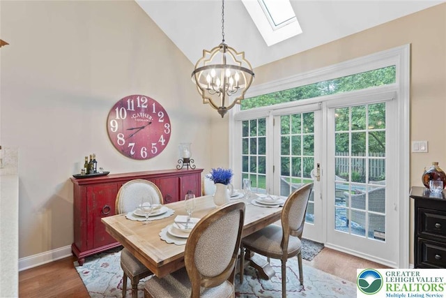 4741 Pinehurst Cir, Upper Saucon Twp, PA 18034 - dining room featuring a chandelier, a skylight, healthy amount of natural light, wood finished floors, and high vaulted ceiling