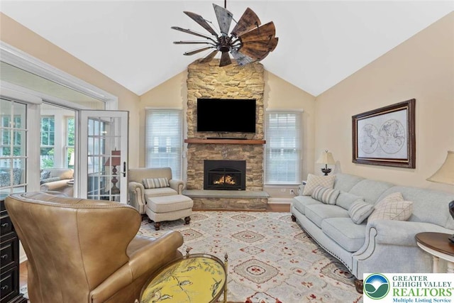 4741 Pinehurst Cir, Upper Saucon Twp, PA 18034 - living room with a ceiling fan, lofted ceiling, a stone fireplace, and wood finished floors