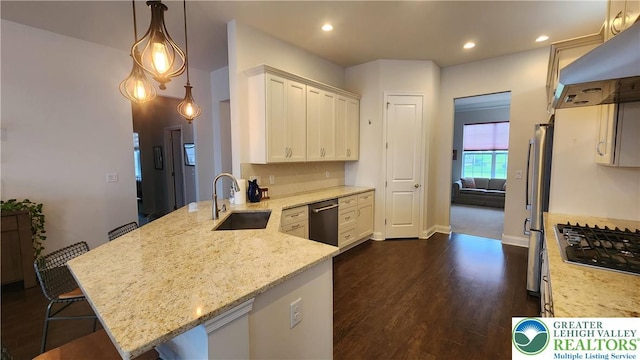 4082 Rutz Ln, South Whitehall Twp, PA 18104 - kitchen featuring a sink, wall chimney exhaust hood, stainless steel appliances, a peninsula, and light stone counters