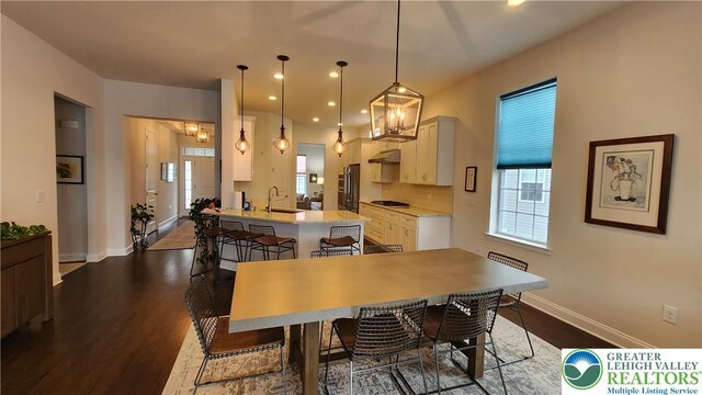 4082 Rutz Ln, South Whitehall Twp, PA 18104 - dining area featuring baseboards, dark wood finished floors, recessed lighting, and a chandelier